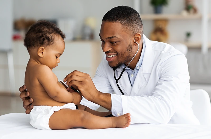 Doctor listening to a baby's heartbeat